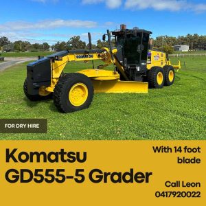 A yellow Komatsu GD555-5 motor grader with a 14-foot blade parked on a grassy field, featured on a promotional banner for equipment dry hire.