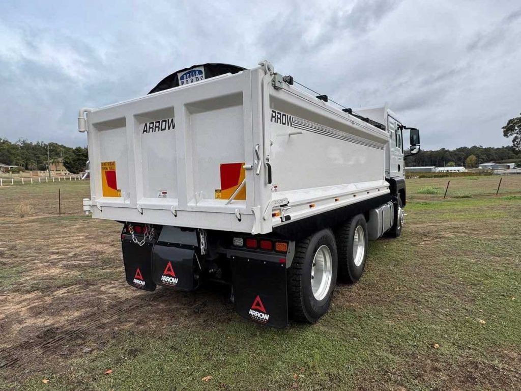 Rear three-quarter view of the white tipper tray box sitting on the truck chassis outdoors.